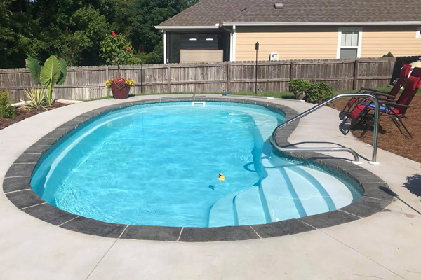 oyster-fiberglass-swimming-pool-next-to-house